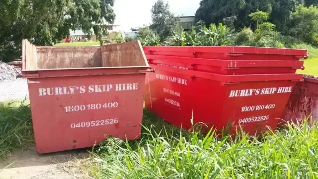 Burly's skip hire empty skip bins on grass